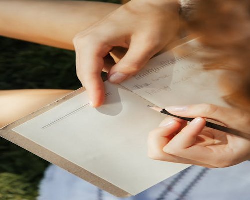 Close up of hand holding a journal for self reflection
