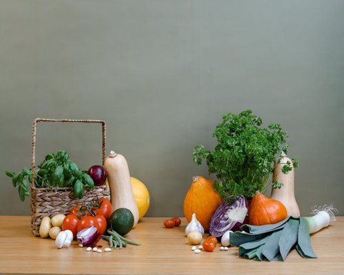 A variety of fresh colorful vegetables and whole grains on a table